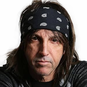 A man with long hair and a bandana on his head.